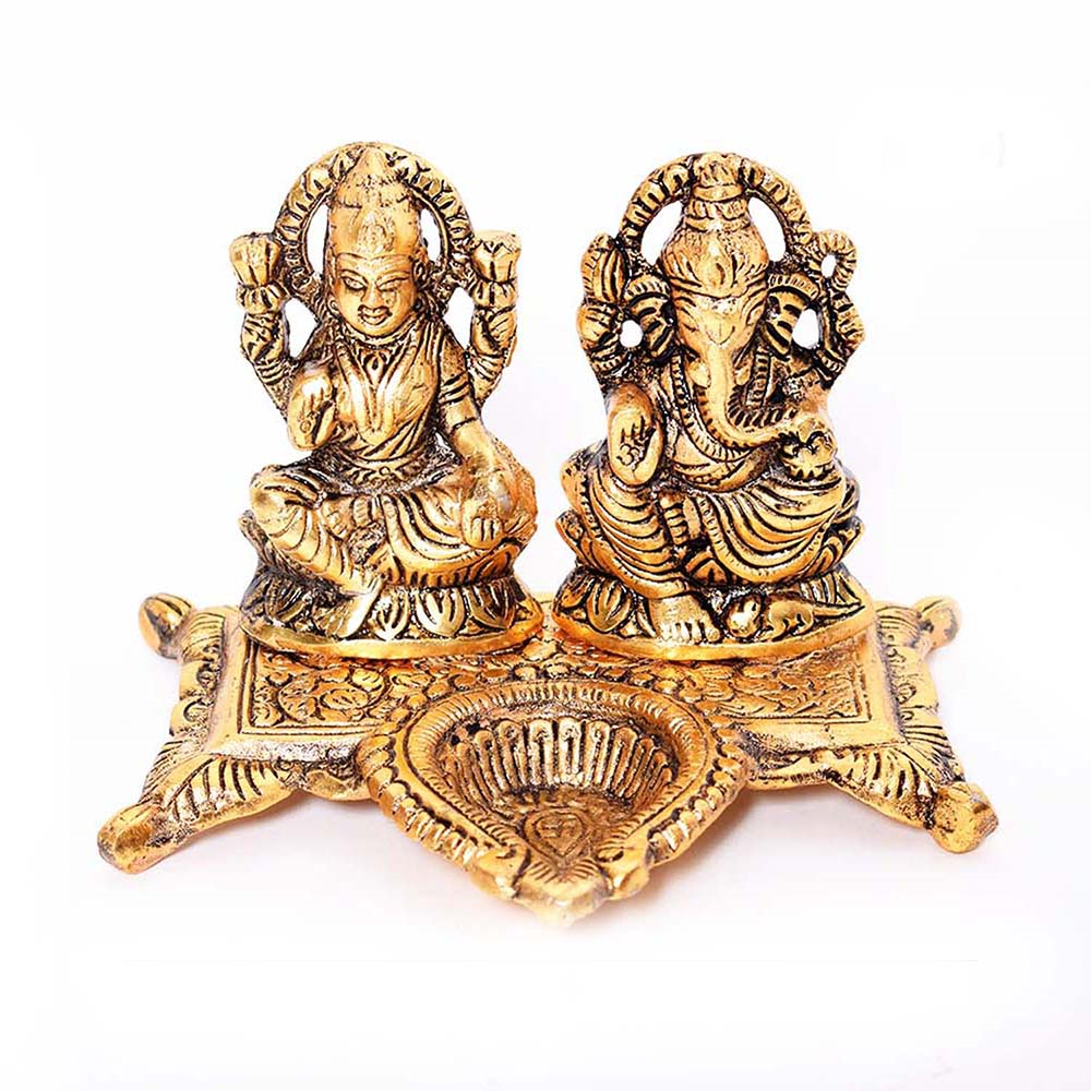 Goddess Laxmi and Lord Ganesha figurine with diya