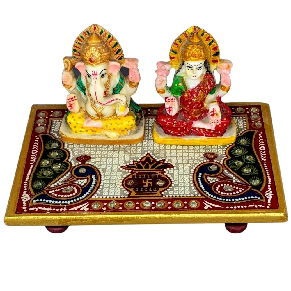Idol of Laxmi and Ganesha sitting on a rectangular chowki